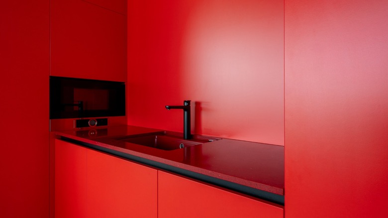 a totally red sink and counters and cupboards