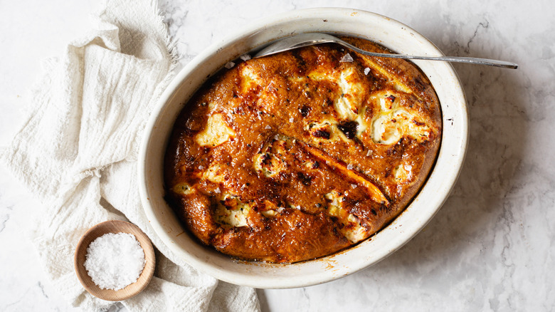 Baked frittata on marble counter with napkin and spoon