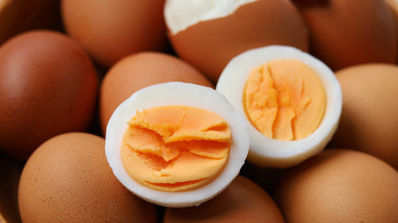 hard boiled eggs cut in half over shelled eggs