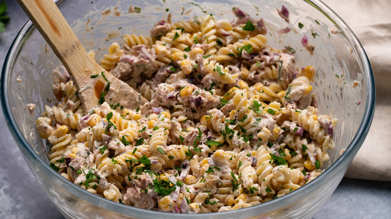Tuna and corn pasta salad in mixing bowl 
