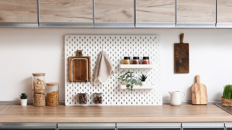 Peg board with hooks displayed on kitchen counter
