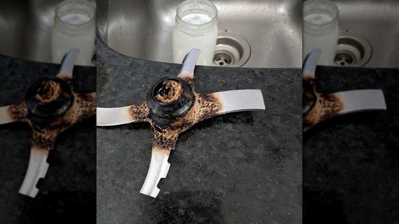 Burnt blade of Ninja CREAMi on countertop in front of sink