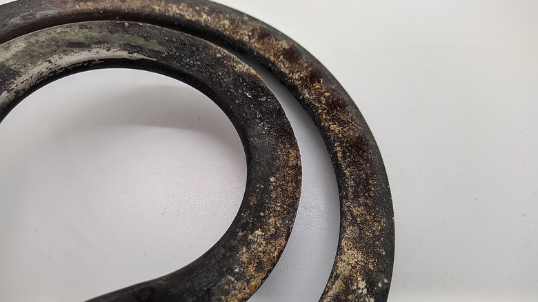 Old and damaged electric stove coil, showing pitting and blistering