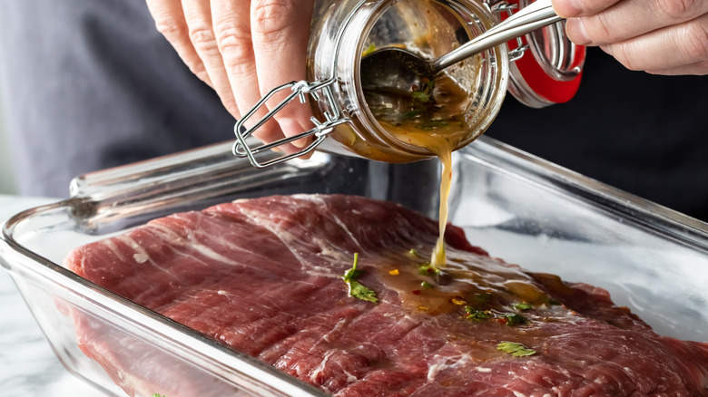 pouring marinade onto beef