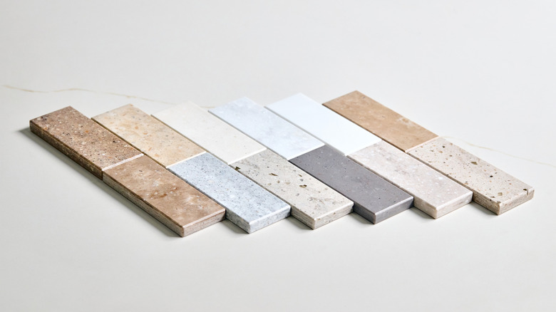 Small samples of different countertop materials laid out for review
