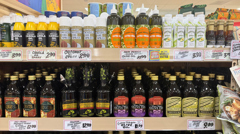 various cooking oils line a Trader Joe's shelf.