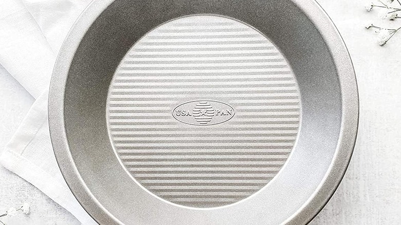 An overhead shot of an empty USA Pan 9-inch pie pan sitting on a white napkin.