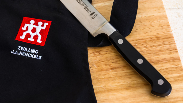 close up of Henckels chef's knife and apron
