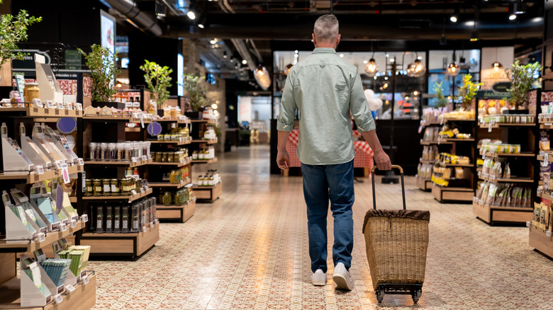 person walking through grocery store