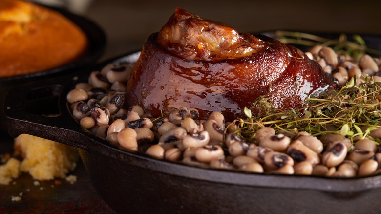 Pot of black-eyed peas topped with a ham hock