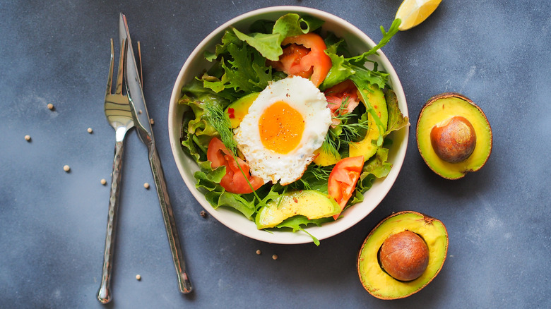 A bowl of avocado fried egg salad