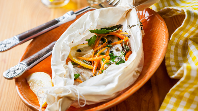 Cooking fish fresh herbs and citrus with parchment paper