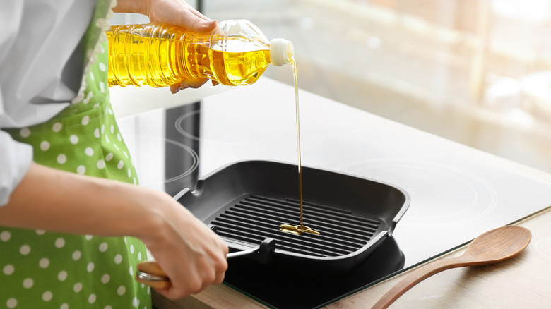 oil pouring on frying pan