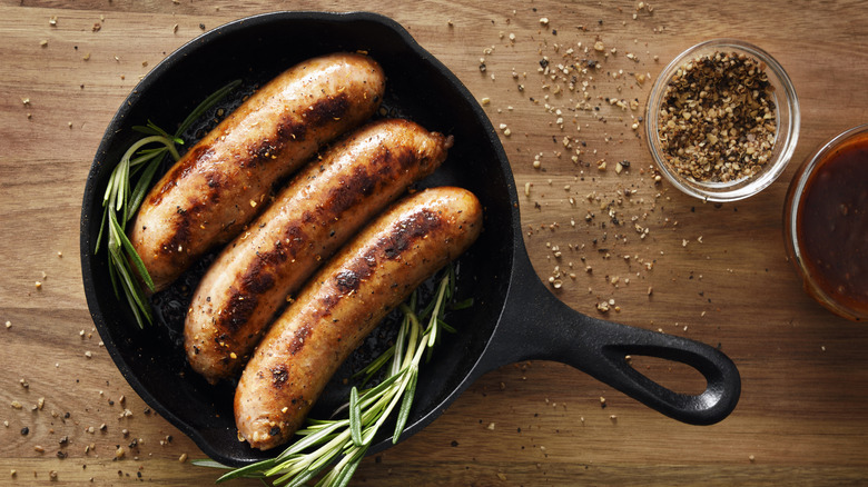 Sausages in cast iron pan.