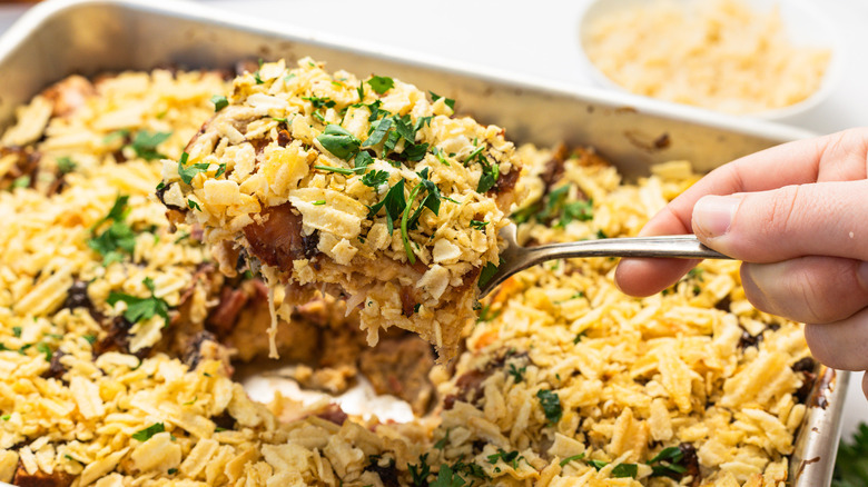 Lifting a serving from the corned beef Reuben casserole.