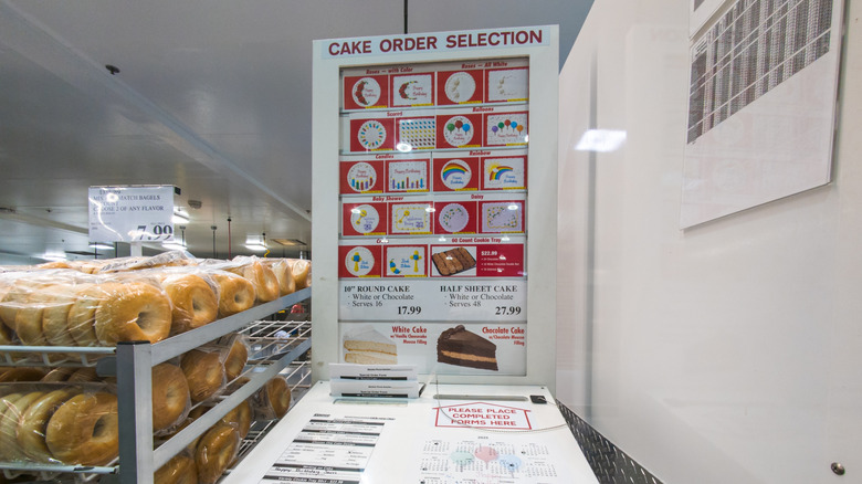 The Costco custom cake ordering kiosk at a warehouse, which allows customers to fill out and deposit paper order forms