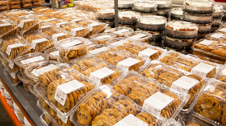 Various Costco desserts, including cinnamon rolls, in plastic trays