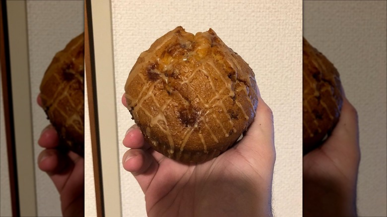 A hand holding a Costco French toast muffin