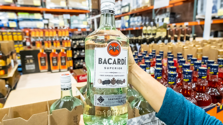 Person holding bottle of Bacardi at Costco