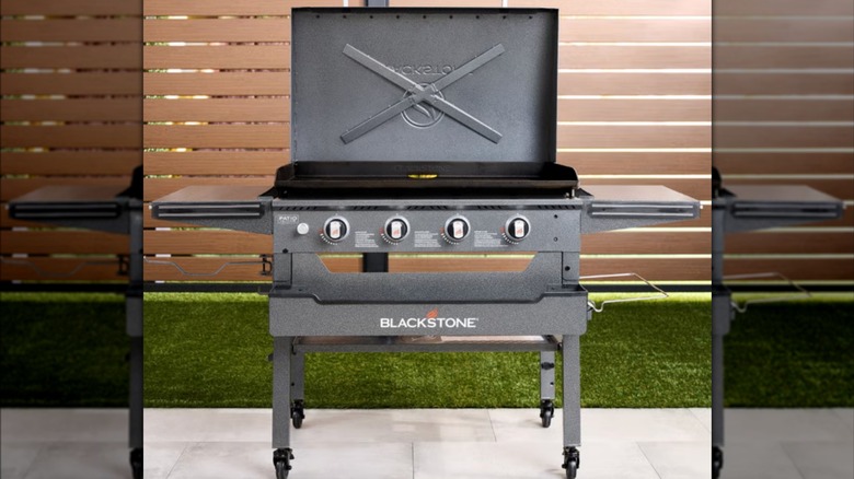 A Blackstone griddle open in backyard
