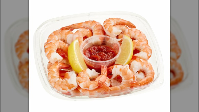 Ready to eat shrimp cocktail from Costco with lemon and sauce in a container