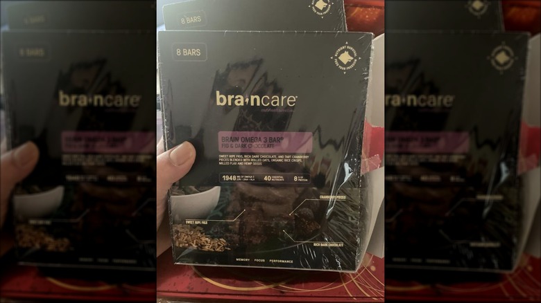 Close-up of a hand holding a box of BrainCare bars
