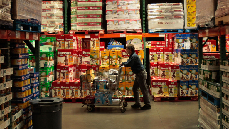 Shopper pushing a cart through a Costco store