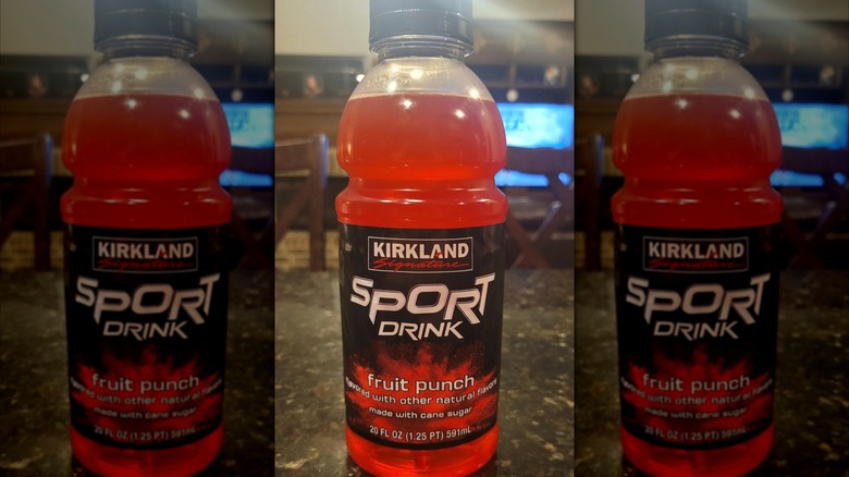 Mirrored image of a red bottle of Kirkland Signature Sport Drink on a countertop