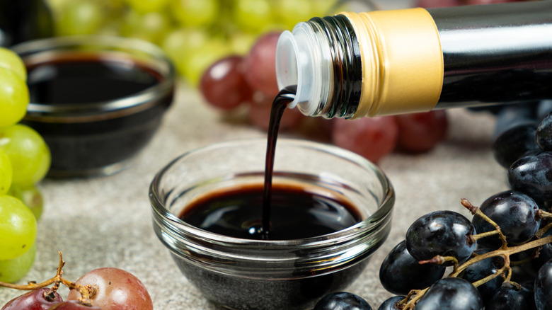 pouring syrupy aged balsamic vinegar in small bowl