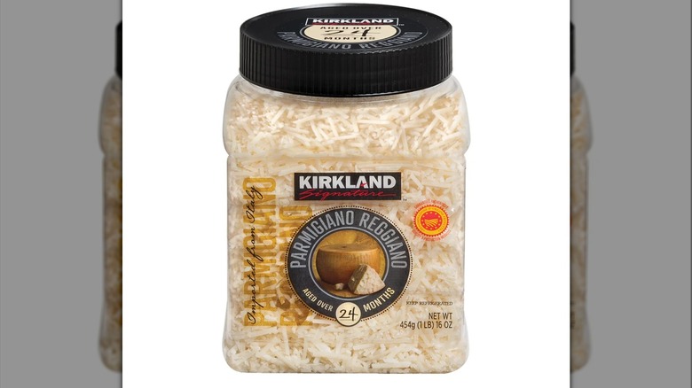 Packaging of Kirkland Signature Aged Parmigiano Reggiano Cheese clear plastic jar against a white background.