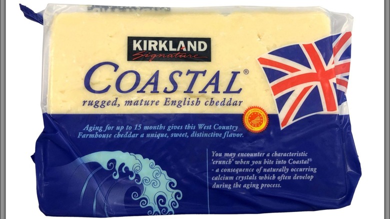 A block of Costal cheddar cheese it it's packaging against a white background.