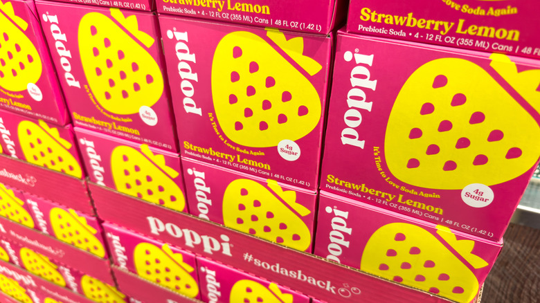 Close-up of probiotic soda cases at a store