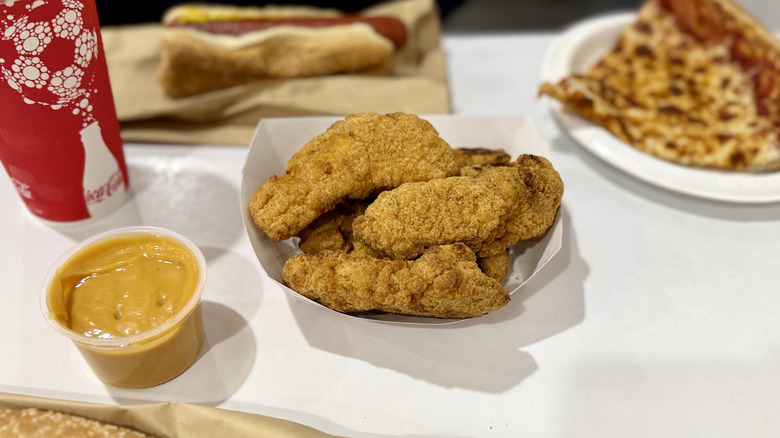 Costco chicken strips on a table with other food court foods