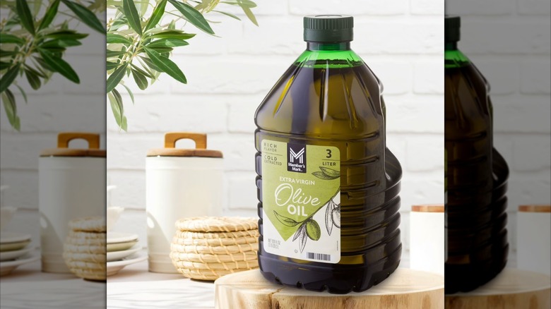 Jug of Sam's Club Member's Mark Extra Virgin Olive Oil on wooden board inside white kitchen