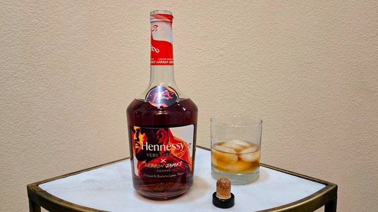 Bottle of Hennessy VS cognac and glass.