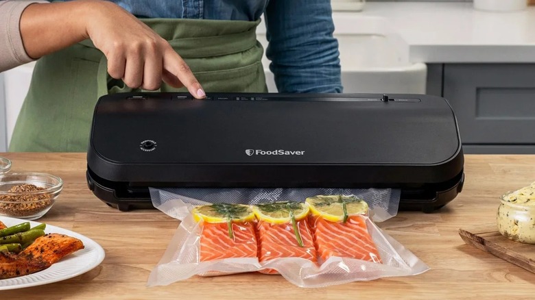 A person using the FoodSaver Preserve Vacuum Sealing System