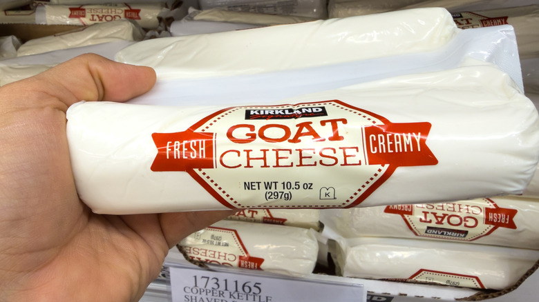 Kirkland Signature goat cheese logs filling cardboard boxes on Costco shelf