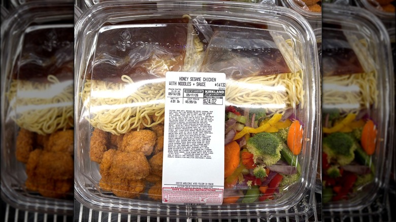 A package of the Costco Honey Sesame Chicken stir-fry prepared meal sitting in the cooler of the deli section