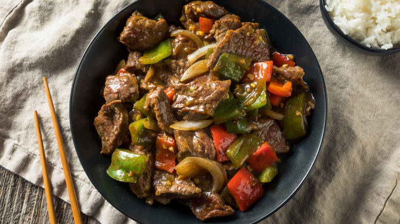 stir fry on plate with chopsticks and rice