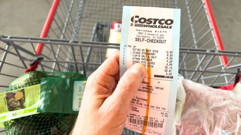 a Costco receipt in store over grocery cart