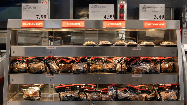 Costco rotisserie chickens on display with $4.99 price tag above