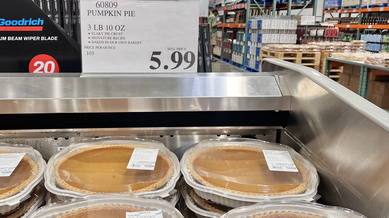 Several Costco pumpkin pies in a refrigerator