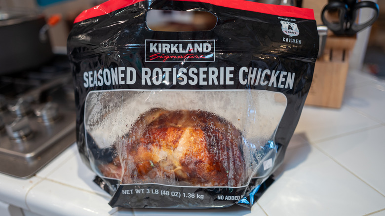 A Kirkland Signature rotisserie chicken in a bag on a kitchen counter