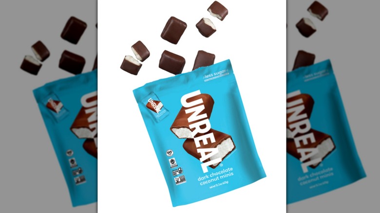 Unreal candy package with a white background and candy coming from the bag