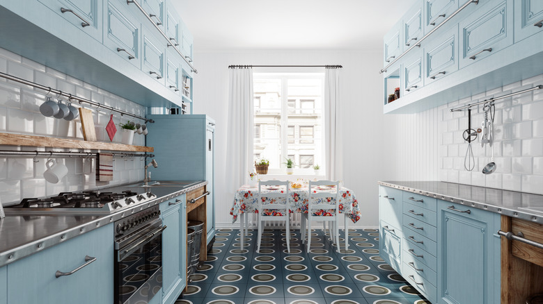 A vintage-inspired kitchen with blue cabinets and a tiled floor