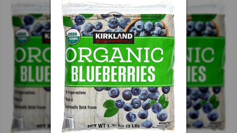 Bag of frozen Costco Kirkland Signature Organic Blueberries on white background