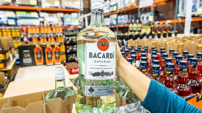 Person holding bottle of Bacardi at Costco