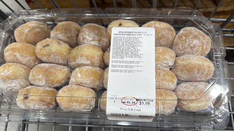 A package of Mini Beignet Filled with Chocolate Hazelnut in a shopping cart at Costco