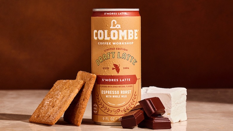 A can of La Colombe S'Mores Draft Latte with graham crackers, marshmallows, and chocolate