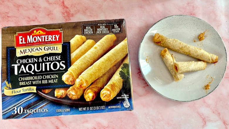 El Monterey Chicken & Cheese Taquitos on white plate next to box, on pink marble surface